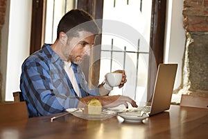 Businessman or student working with laptop computer at coffee shop having breakfast
