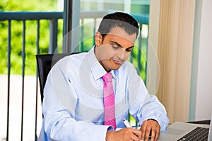 Businessman or student working laptop and writing