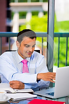 Businessman or student working laptop and writing