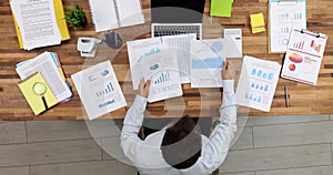 Businessman studying documents with graphs at table in office top view 4k movie