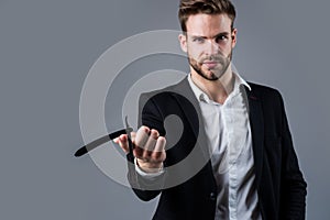 businessman or stylist. male hairdresser and barbershop. man hold razor blade for cutting hair. beard and hair care