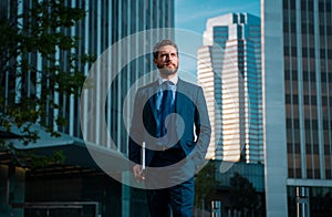 Businessman with success business. Outdoors portrait male model in suit. Businessman walking.