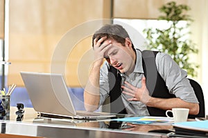 Businessman suffering an anxiety attack photo