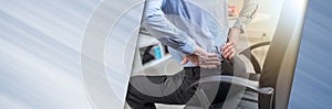 Businessman suffering from back pain, panoramic banner