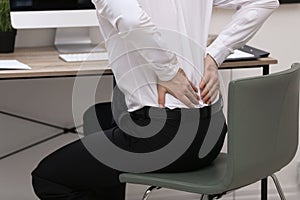Businessman suffering from back pain at workplace