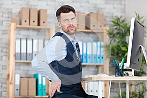 businessman suffering from backache in office