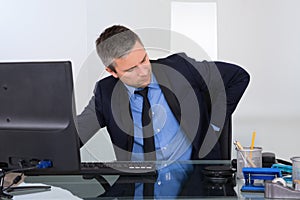 Businessman suffering from backpain photo