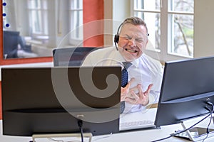 Businessman suffering a heart attack at work in office