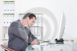 Businessman suffering from neck pain