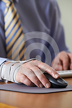 Businessman Suffering From Repetitive Strain Injury (RSI)