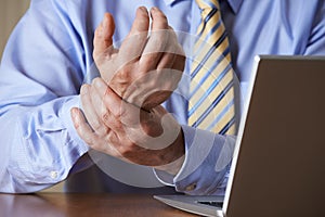 Businessman Suffering From Repetitive Strain Injury (RSI)