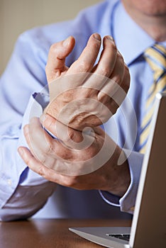 Businessman Suffering From Repetitive Strain Injury (RSI)