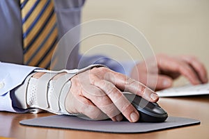 Businessman Suffering From Repetitive Strain Injury (RSI)