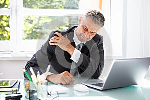 Businessman Suffering From Shoulder Pain