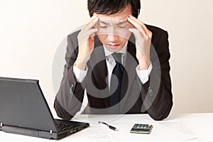 Businessman suffers from headache or Asthenopia