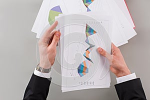 Businessman in suit analysing graphs and charts.