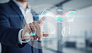 Businessman analyzing data on virtual screen.