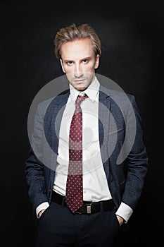 Businessman in Suit on Black Background. Young Man