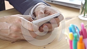Businessman in suit chat or typing or play smartphone close up
