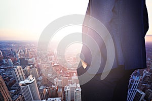 Businessman in suit at Chicago sunset view window