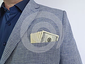 Businessman in suit dollars in pocket closeup formal