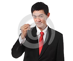 Businessman in a suit with a gold tie color holding a pen and writing something, isolated on white background