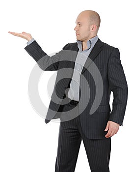 Businessman in a suit holds her hand, palm up.