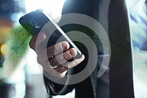 Businessman in suit, jacket,shirt, tie, using his smart phone