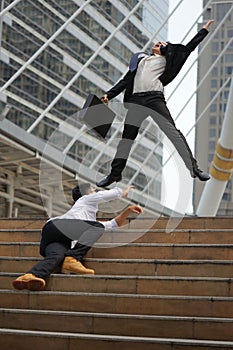 Businessman in suit jumping feeling happy when he success