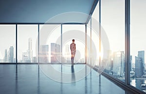 Businessman in suit looking at sunrise in the city. 3d render