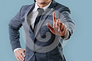 Businessman in suit making objection gesture , holding index finger up over blue photo