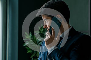 Businessman in suit with mobile phone in hands. Man typing message, using social net. Checking news. Making business