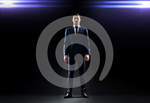 Businessman in suit over black with laser light