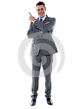 Businessman in suit pointing at copyspace