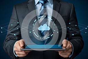 Businessman holding tablet displaying cloud computing technology and network connections concept