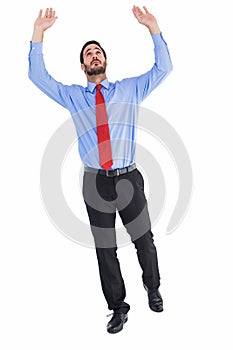 Businessman in suit pushing up with effort