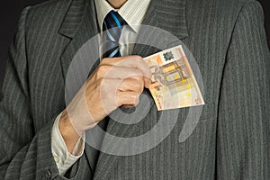 Businessman hand holding money, euro bills. Banknotes isolated gray background.