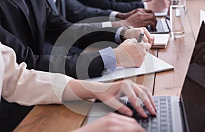 Businessman in suit putting signature on contract