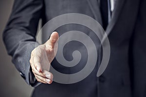 Businessman in suit ready to handshake with trust and profession