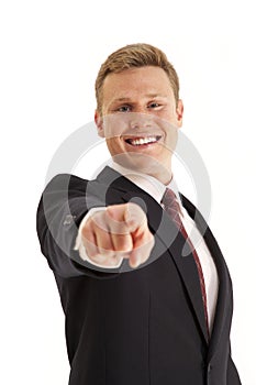 Businessman in suit rpointing finger at camera