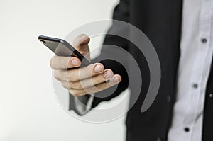 Businessman in suit showing something with pen.