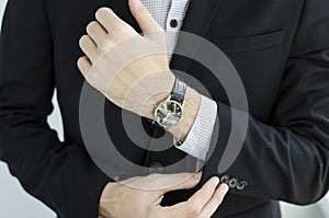 Businessman in suit showing something with pen.