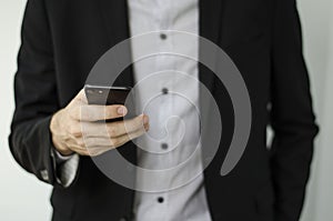 Businessman in suit showing something with pen.