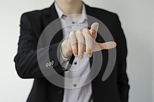 Businessman in suit showing something with pen.