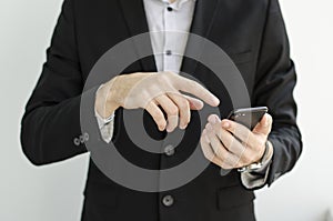 Businessman in suit showing something with pen.