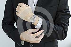 Businessman in suit showing something with pen.