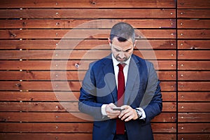 Businessman in a suit with smartphone