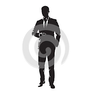 Businessman in suit standing with one hand in pocket. Isolated vector silhouette, front view. Business people
