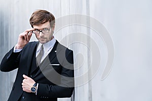 Businessman in suit take off glasses looking at camera