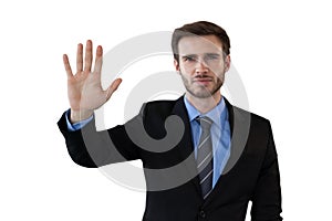 Businessman in suit touching invisible interface